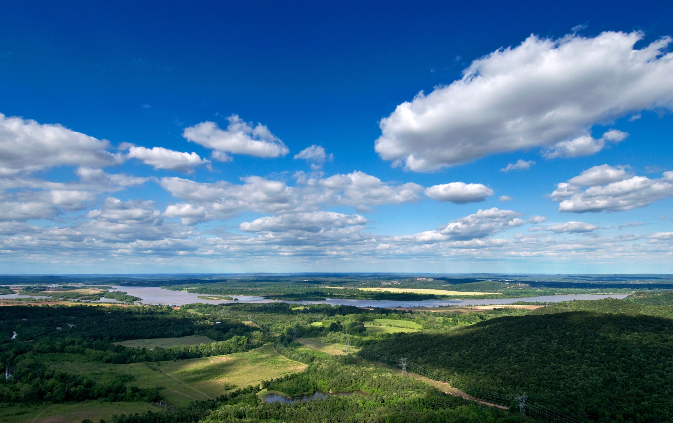 Rolling green hills beneath a blue sky